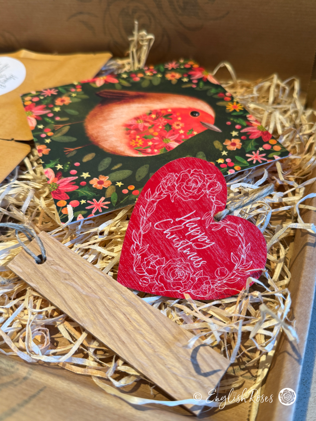 Inside the Christmas letterbox gift with the robin design greetings card, 'Happy Christmas' Wooden Tag and wooden name label.