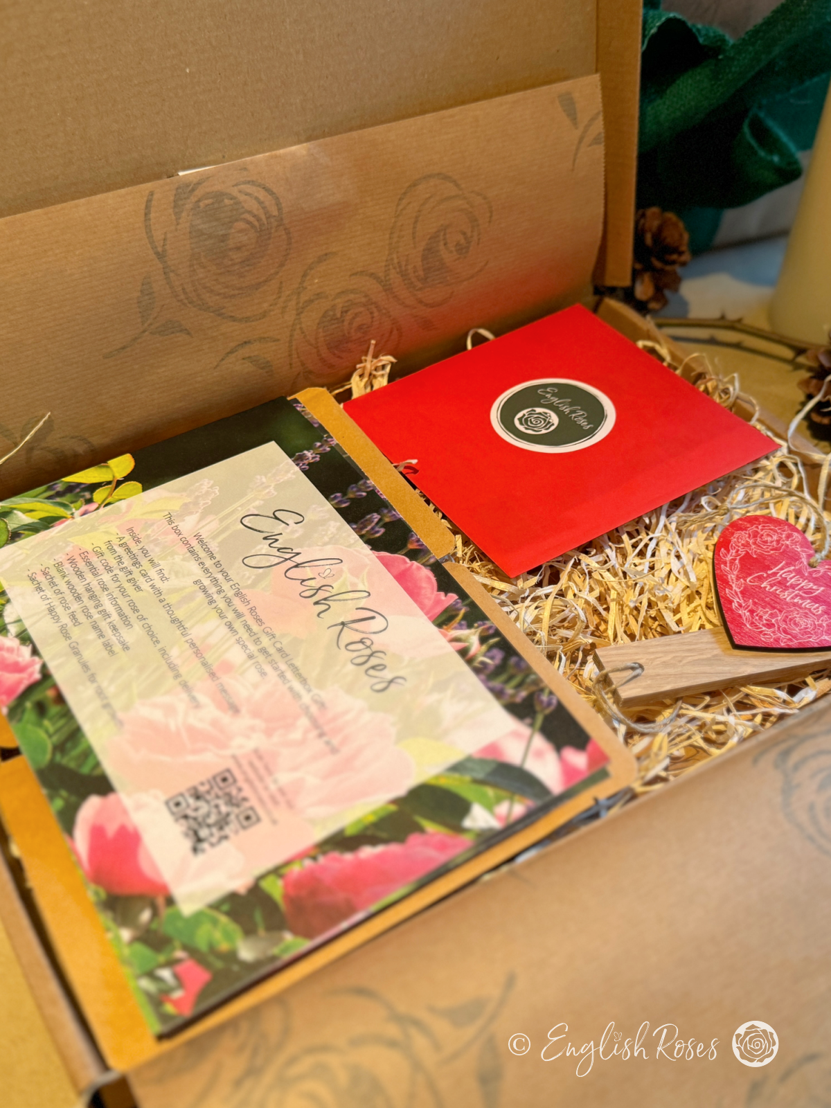 Inside the Christmas letterbox gift with the rose feed, rose granules, help guides, greetings card, name tag and gift tag.