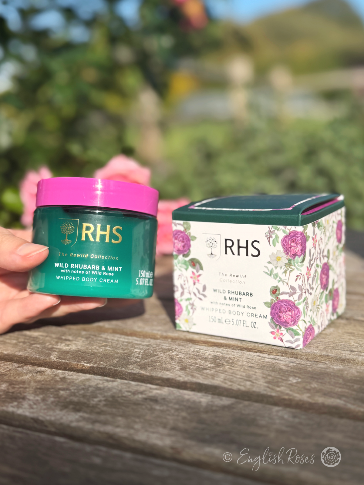 Body Cream - Wild Rhubarb and Mint RHS The Rewild Collection - A hand holding the tub of body cream with the box
