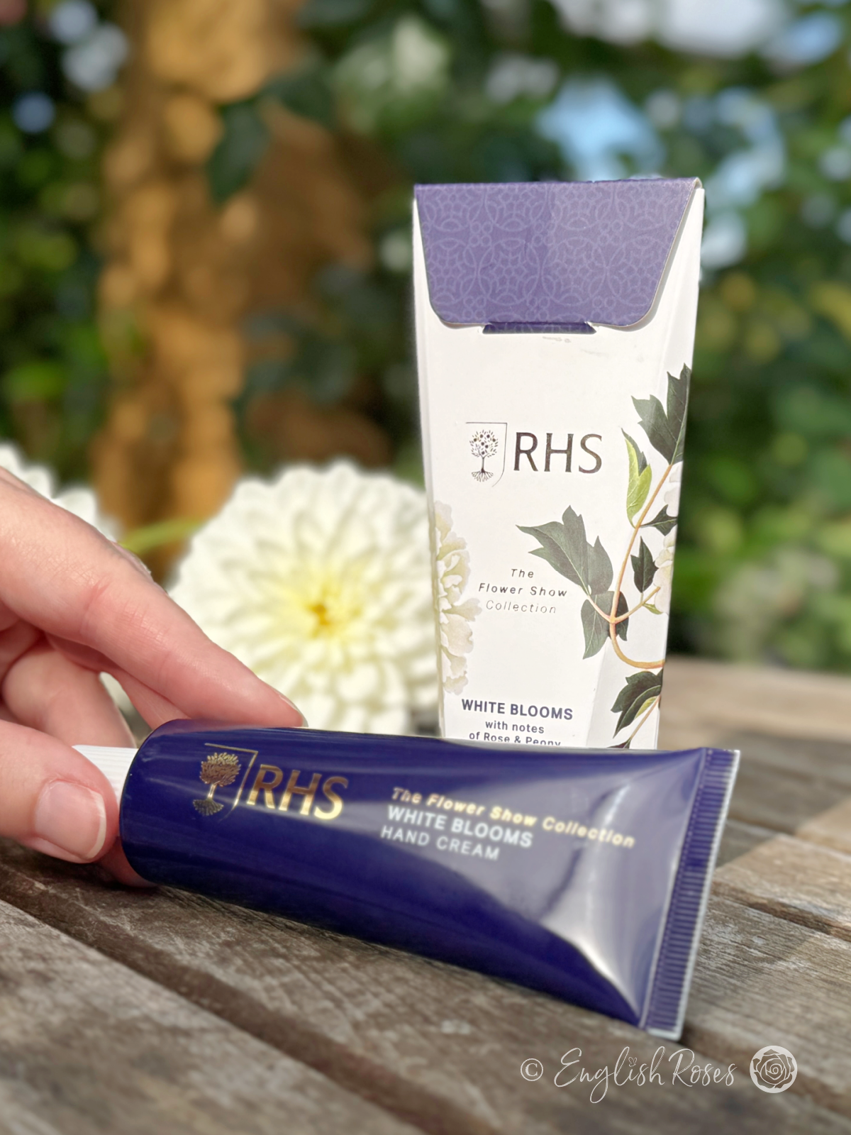 Hand Cream - White Blooms Rose and Peony RHS The Flower Show Collection - A hand holding the tube with the box