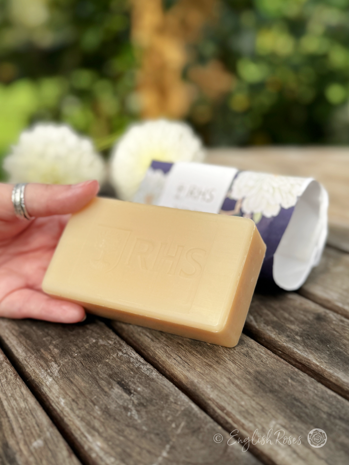 Soap Bar - White Blooms Rose and Peony RHS The Flower Show Collection - A hand holding the bar of soap with the packaging